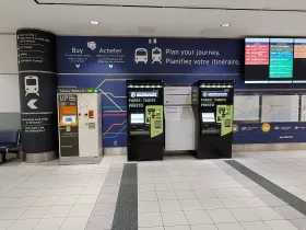 Ticket machines. UP Express train on the left, buses on the right